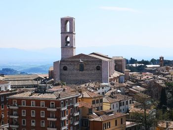 High angle view of buildings in town against sky