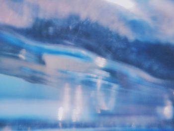 Blurred motion of illuminated glass against blue sky