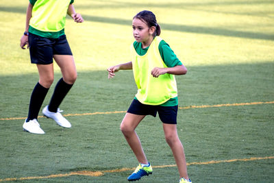 Girl playing soccer on field