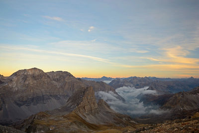 Scenic view of snowcapped mountains against sky during sunset