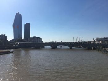 Bridge over river with buildings in background