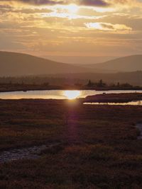 Scenic view of sunset over land