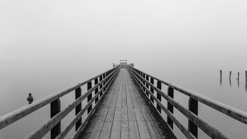 Pier over sea against sky