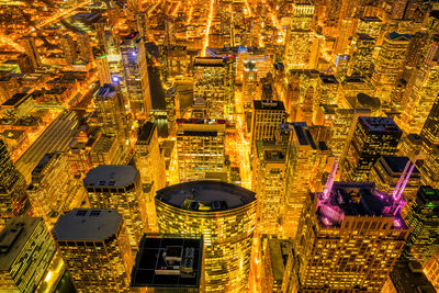 High angle view of illuminated buildings in city at night