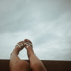 Low section of woman against clear sky