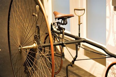 Close-up of bicycle parked against wall