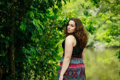 Rear view portrait of teenage girl standing at park