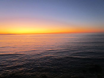Scenic view of sea against orange sky