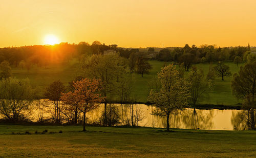 Scenic view of field against sky during sunset