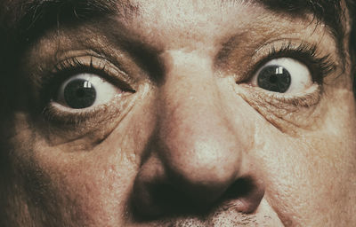 Close-up portrait of shocked man at home