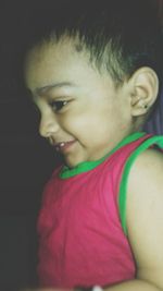 Close-up portrait of smiling boy at home