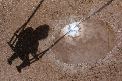 Shadow of man on road