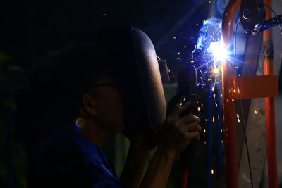 Manual worker welding in factory