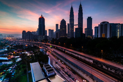 Petronas towers against sky during sunset in city