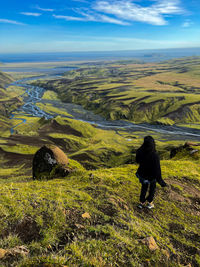 Rear view of woman standing on landscape