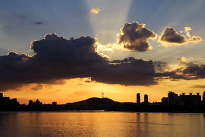 Silhouette buildings against sky during sunset