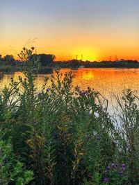 Scenic view of lake against sky during sunset