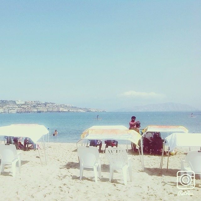 beach, sea, sand, water, shore, horizon over water, clear sky, vacations, beach umbrella, copy space, parasol, relaxation, tranquil scene, lounge chair, summer, nature, sky, tranquility, chair, day