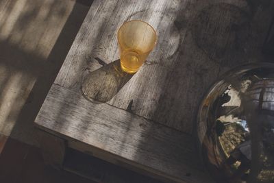 High angle view of a glass on wooden table