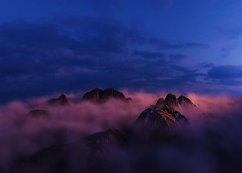 Scenic view of mountains against sky at sunset
