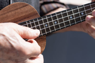 Close-up of hand playing guitar