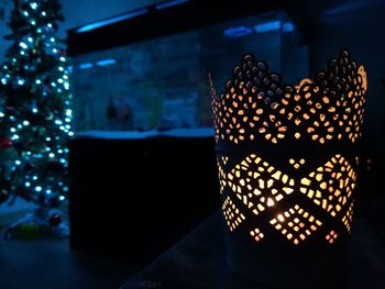 Close-up of illuminated lamp on table at home