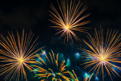 Low angle view of firework display at night