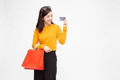 Young woman standing against white background