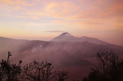 Scenic view of mountains against cloudy sky