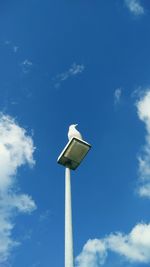 Low angle view of statue against blue sky