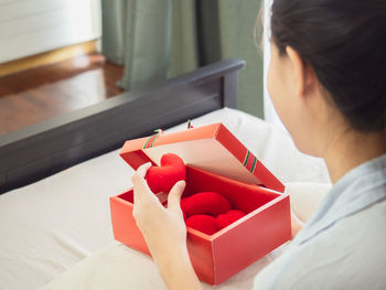 High angle view of woman holding umbrella at home