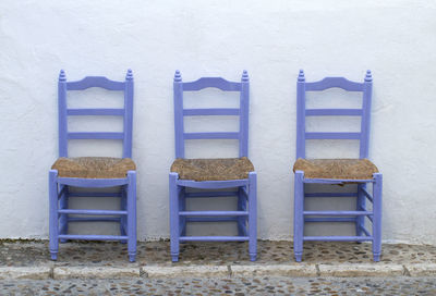 Close-up of chairs on sand