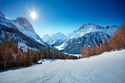 Scenic view of snow covered mountains against sky