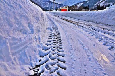 Tire tracks on snow covered road