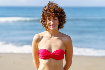 Portrait of young woman in bikini at beach