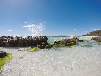 Scenic view of sea against clear blue sky