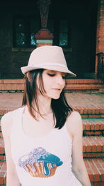 Portrait of young woman wearing hat