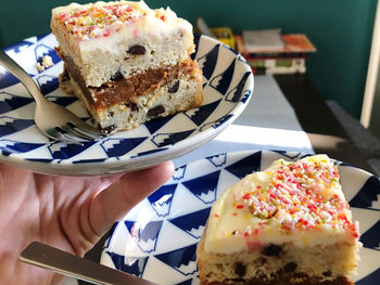 Close-up of hand holding cake