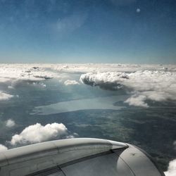 Cropped image of airplane flying over landscape