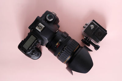 Close-up of camera against yellow background