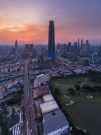 High angle view of modern buildings against sky during sunset