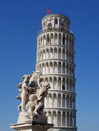 Sculptures by leaning tower of pisa