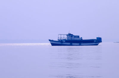 Ship on sea against clear sky