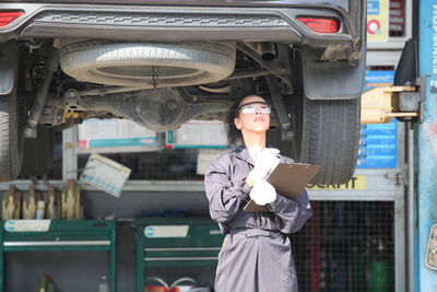 Man working with woman standing in car