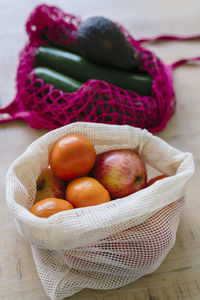 Eco friendly and reusable shopping mesh bag with fruits and vegetables