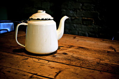 Close-up of tea kettle on wooden table