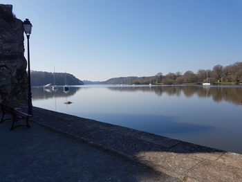 Scenic view of lake against clear blue sky