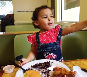 Girl having lunch on table at restaurant