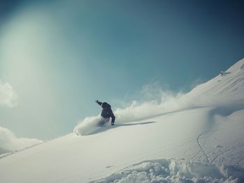 Full length of woman standing on snow covered mountain