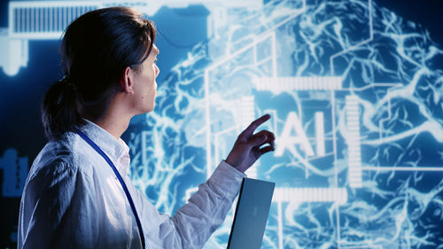 Side view of businessman using mobile phone